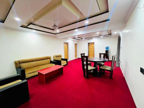 a room with a couch and a table and chairs at Zim Zim &Salaar Gust House in Skardu