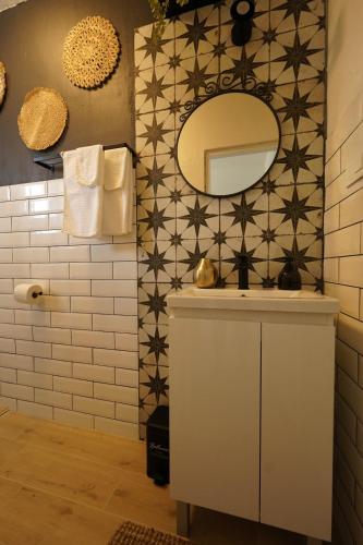 a bathroom with a mirror and a sink at L'infini Sea View apartments Zubovići in Zubovići