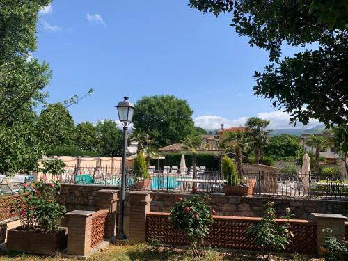 a street light in a yard with a pool at Residenza Le Querce Trilocale in Fossato di Vico