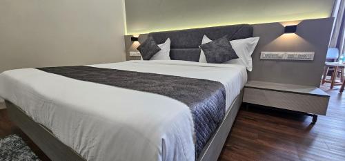 a bedroom with a large bed in a room at Hotel Great View in Sangli