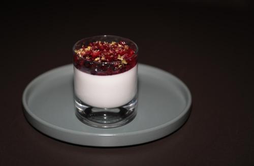 a glass of dessert on a plate on a table at Best Western Premier Batumi in Batumi