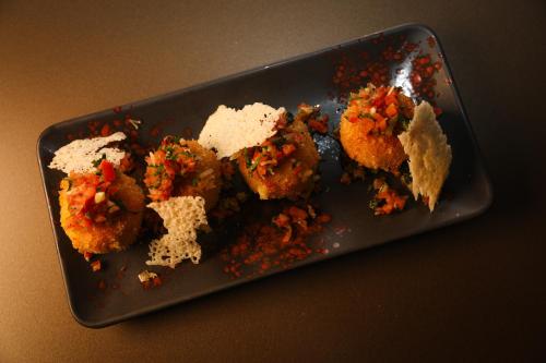 a black plate with food on a table at Best Western Premier Batumi in Batumi