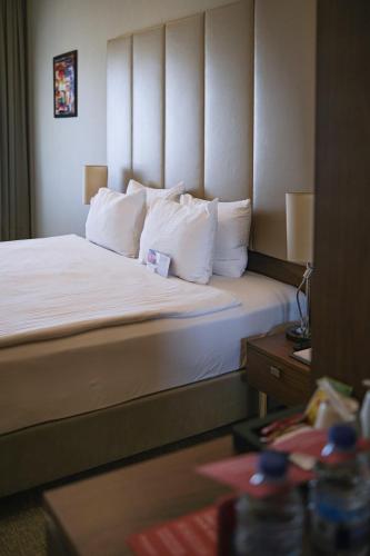 a hotel room with a bed with white pillows at Ramada by Wyndham Yalova in Yalova