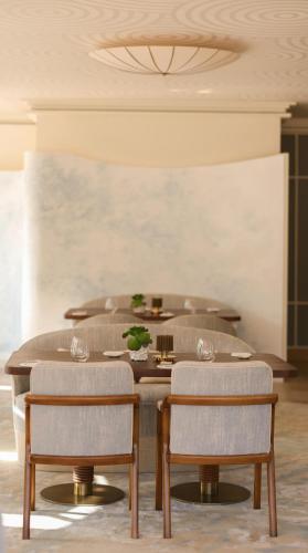 a dining room with a table and four chairs at Villa Miraé by Inwood Hotels - Cap d'Antibes in Antibes