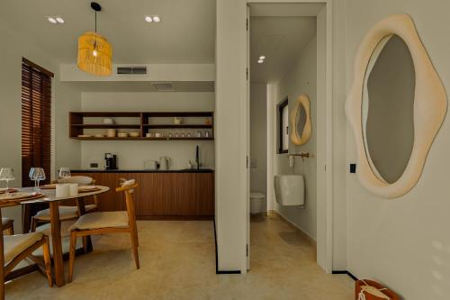 a dining room and kitchen with a table and a mirror at Tellion Cave Villas in Agios Nikitas