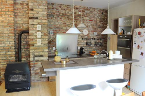 a kitchen with a counter and a brick wall at Crystal Kragujevac in Kragujevac