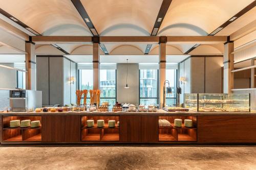a large kitchen with a buffet in a building at Holiday Inn Changchun High Tech Zone by IHG in Changchun