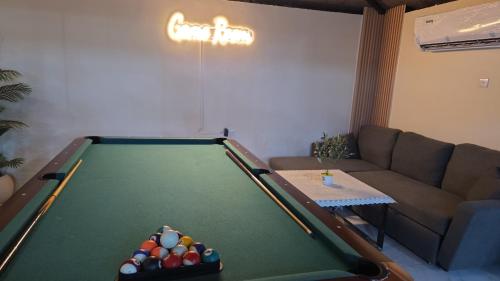 a living room with a pool table and a couch at استراحة دار العين in Al Ain