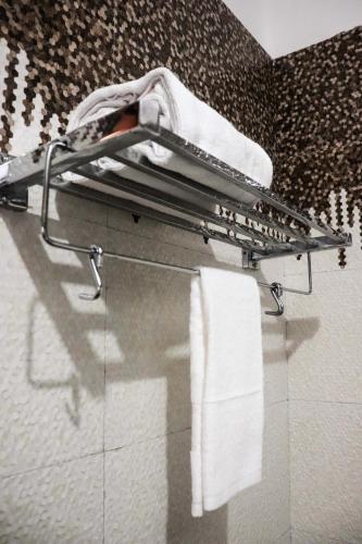 a towel rack in a bathroom with towels at Vedika Hotel Restaurant & Banquet in Rānchī
