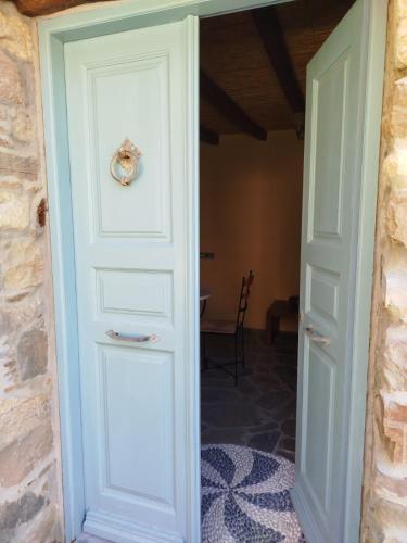 a door leading into a room with a table at Volissos Sea View Maisonettes in Volissos