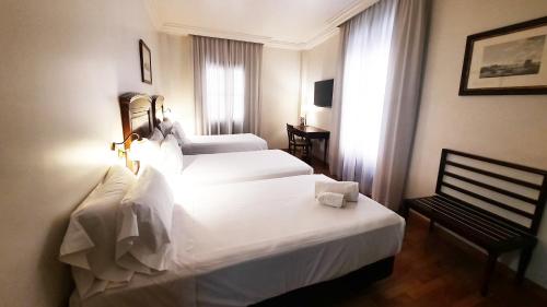 Ένα ή περισσότερα κρεβάτια σε δωμάτιο στο Sercotel Palacio de los Gamboa