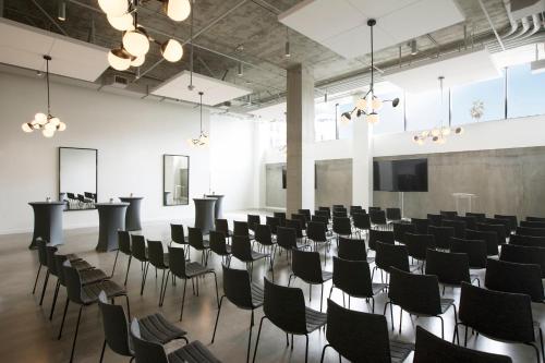 a room with rows of chairs and a lectern at Kimpton Everly Hotel Hollywood by IHG in Los Angeles