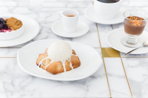 a table with a plate of cake with an ice cream on it at Kimpton Everly Hotel Hollywood by IHG in Los Angeles