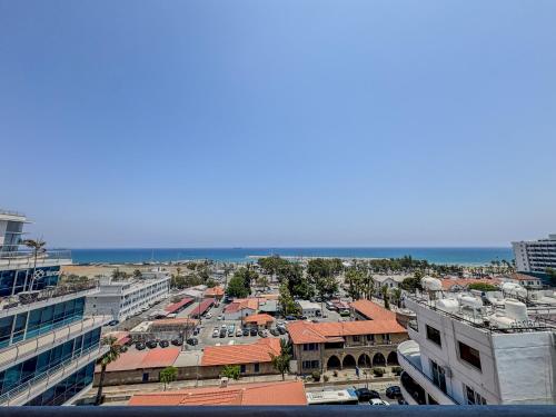 an aerial view of a city with buildings and the ocean at Sea View City Beach Apartment in Larnaka