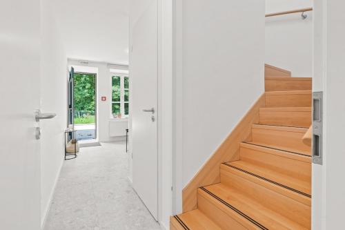 a hallway with wooden stairs in a house at Gîte Lasauvage 85 in Differdange