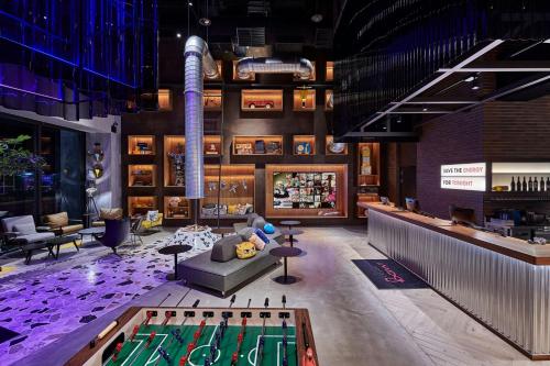 a lobby with a pool table in a building at Moxy Taichung in Taichung