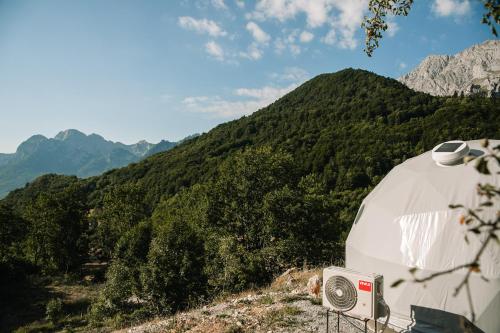 a white camper with a view of a mountain at Ursa Camp in Gornje Lipovo