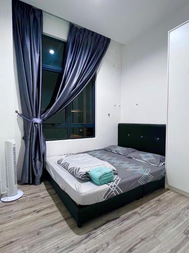 a bedroom with a bed and a window with a curtain at Zen 66 apartment in Kuching