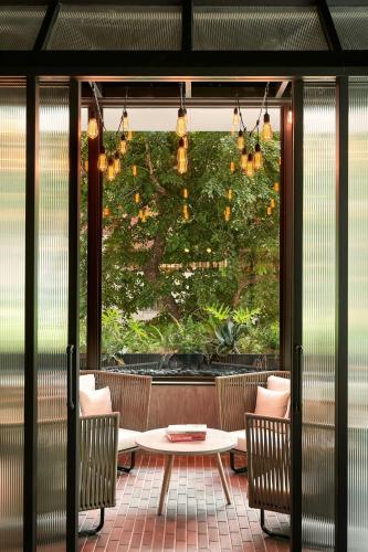 a patio with a table and chairs and a window at Moxy Taichung in Taichung