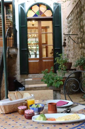 a table with a plate of food on a table at Hotel Casa Bougainvillea in Sóller