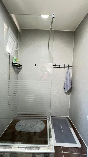 a shower with a glass door in a bathroom at Guest House Bosnian House in Sarajevo