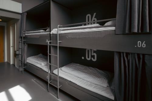 a room with three bunk beds in a room at Roberta's Society Aarhus in Aarhus