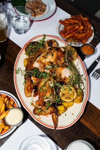 a plate of food on a table with french fries at Roberta's Society Aarhus in Aarhus