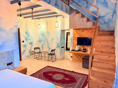 a bedroom with a staircase and a table and chairs at Passiflora Beach Resort Alibaug in Alibaug