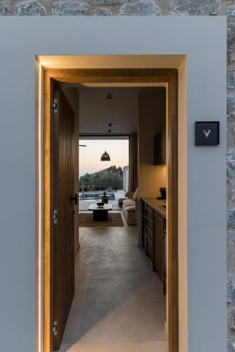 a hallway leading to a kitchen with a view of a living room at Castor & Pollux in Kotrónion