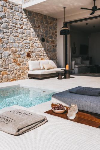 a living room with a swimming pool and a couch at Castor & Pollux in Kotrónion