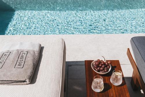 a bowl of fruit on a table next to a pool at Castor & Pollux in Kotrónion