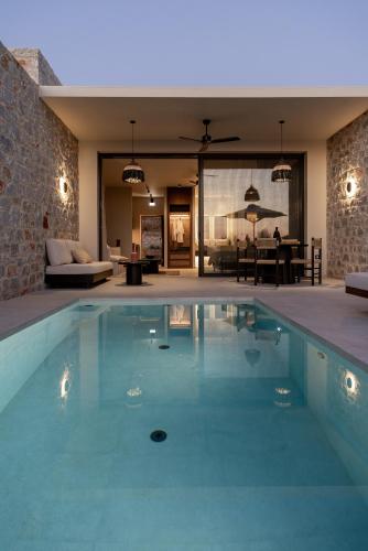 a swimming pool in a house with a living room at Castor & Pollux in Kotrónion