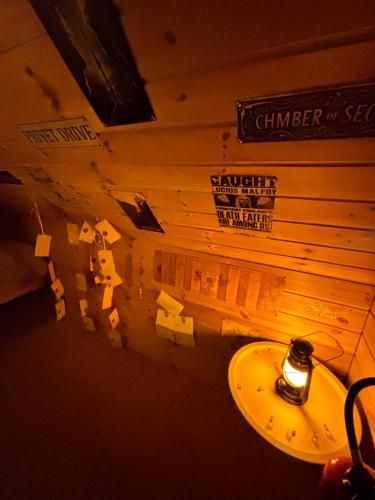 a bathroom with a wall with signs on it at Gite Clé des Champs in Montenois