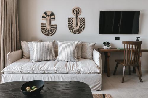 a living room with a couch and a tv at Castor & Pollux in Kotrónion