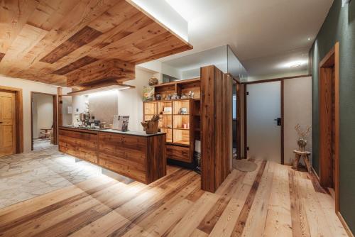 a large room with wooden floors and wooden ceilings at Hotel Bellavista in Cavalese