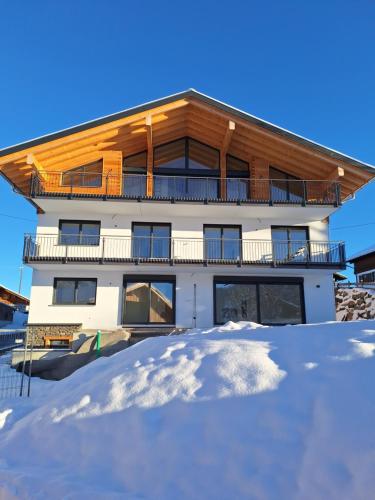 a building with snow in front of it at Beim Hofar - die neuen Ferienwohnungen in Obermaiselstein in Obermaiselstein