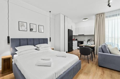 a bedroom with a large bed and a couch at Artemis 103 - Seaside Stories in Livadhia