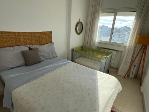a bedroom with a bed and a window at Mahdia front sea balcony 2 in Hiboun