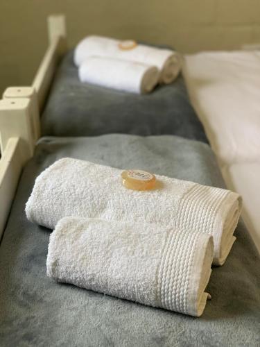 two white towels sitting on a bed with at Venolla's in The Crags