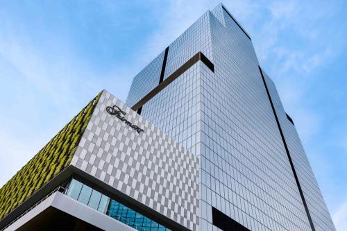 a tall building with a cazon sign on it at Fairmont Tokyo in Tokyo