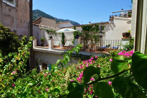 a view of a balcony with pink flowers at Hotel Can Abril in Sóller