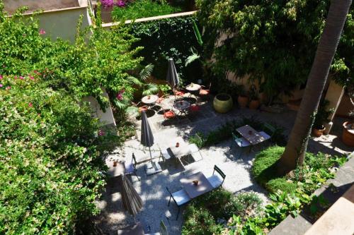 an overhead view of a patio with tables and umbrellas at Hotel Can Abril in Sóller