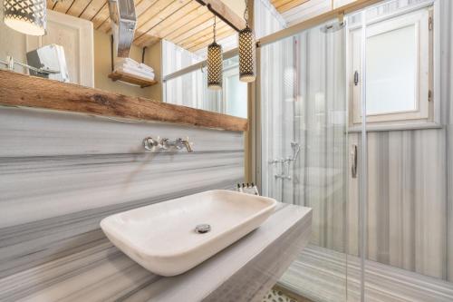 a bathroom with a sink and a shower at Hotel Unique-Boutique Class - Adults Only in Fethiye