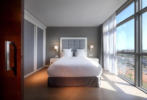 a bedroom with a large bed and a large window at Domo Casablanca in Casablanca