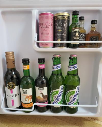 a refrigerator filled with lots of bottles of beer at Adac Boutique Hotel in Bucharest