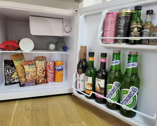 an open refrigerator filled with lots of drinks and snacks at Adac Boutique Hotel in Bucharest