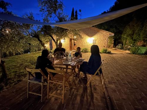 a group of people sitting at a table at night at Spello Sant'Onofrio in Spello