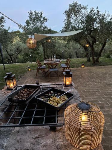 a patio with a grill with a table and a picnic table at Spello Sant'Onofrio in Spello