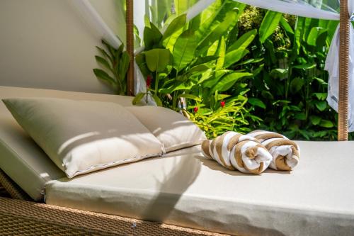a bed with two pillows and aafia at Frelin Villas - 1 BR, 2 BR Luxury Villa Complex in Kerobokan