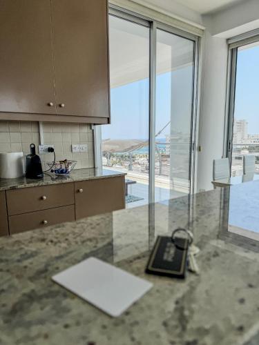 a kitchen with a counter with a book on it at Sea View City Beach Apartment in Larnaka